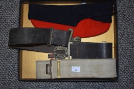A Red and Black Military Forage Cap, Military Canvas Webbing Belt and a Leather Belt with a City