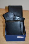 A collection of gentleman's black leather wallets and other holders