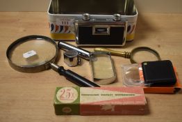 A pair of vintage folding pocket binoculars together with magnifying glasses and a jeweller's loop