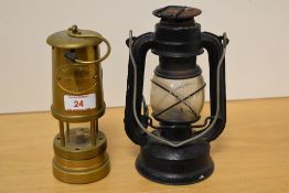 A small vintage kerosene storm lantern sold together with a brass miners type lamp marked 'Ashington