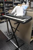 A Yamaha PSR-150 keyboard, stand and music books