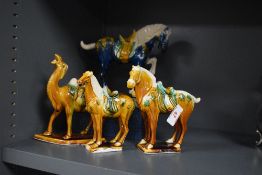 A Chinese Tang Style and Sancai glazed camel study, measuring 16.5cm high, together with three