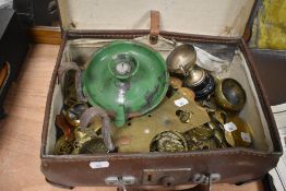 An early 20th Century brown leather case containing various metalware including a green enamelled