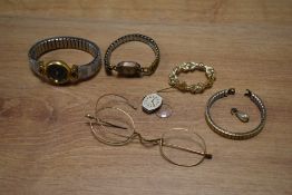 A small assortment of costume jewellery, including wristwatches, a brooch and a vintage glasses