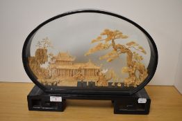 A Chinese glazed and lacquered wood framed cork diorama, depicting pagodas, trees and birds, the