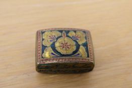 A small decorative engraved and enamelled brass box, engraved and decorated with flowers and