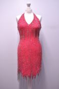 Four embellished sleeveless dresses, harking of the mid-1920's flapper era. A 1980's knee-length