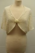 A Nicholas Millington short sleeved bolero top, with an all over pearl bead trim, 1 large pearl