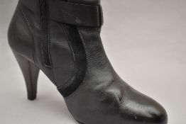 A pair of Ted Baker knee high boots in black leather, inside-calf zip closure, featuring black