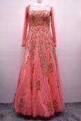 A modern Monga bridesmaid or occasion dress, of the Indian modest style, in coral pink netting