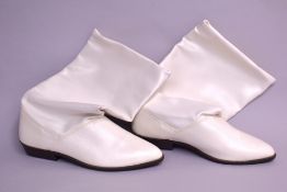 A pair of 1960s gogo boots in white smooth leather, with a round point toe, slouchy calf-height