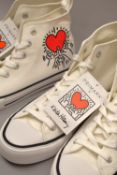 Two pairs of Primark baseball shoes, produced in collaboration with the Keith Haring Association