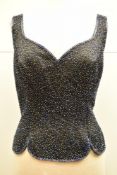 A midnight blue fitted sleeveless bustier style top with all over seed beading in tonal blue, black,