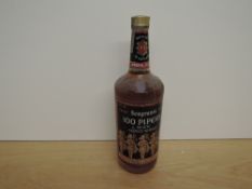 A bottle of 1970's Seagram's 100 Pipers De Luxe Scotch Whisky, distilled and blended in Scotland