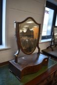 An Edwardian toilet mirror having serpentine fronted drawer base