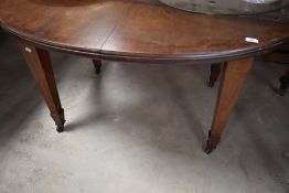 A late 19th or early 20th Century oval windout dining table of oval form on square tapered legs with