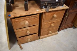 A pair of natural pine bedside chests of three drawers, width approx. 41cm