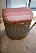 A vintage Lloyd Loom half moon linen basket stool
