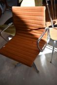 A vintage chrome framed swivel office armchair