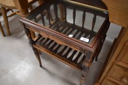 A reproduction occasional table having glass top, slatted undertier and turned legs