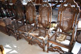 A set of four (two plus two) oak Carolean style chairs having cane seats and back panels