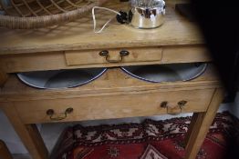 A Victorian stripped pine wash stand having pull out front revealing enamelled water bowls, width