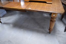 A Victorian oak extending dining table on turned legs , approx. 190 x 126cm extended