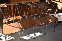 A set of four vintage chrome framed kitchen chairs of stylised design