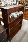An oak open bookcase with four adjustable shelves, short ogee bracket type feet to base 125cm high