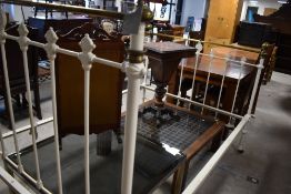 A Victorian cast metal bed frame with brass detailing, approx width 135cm