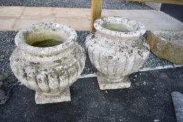 A pair of concrete garden urns