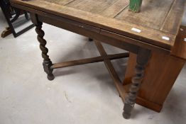 An early 20th Century oak drawer leaf dining table on barley twist legs, approx. 92 x 92cm