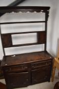 A 19th Century Jacobean style oak dresser having open delft rack, width approx. 122cm