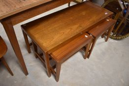 A vintage teak coffee table nest