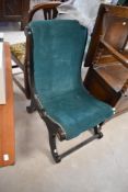 An ebonised savanarola style easy chair