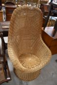 A vintage style wickerwork easy chair
