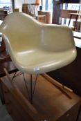 A vintage Eames style fibreglass rocking chair having cats cradle frame