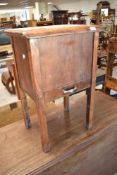 A 20th century walnut sewing cabinet, having a hinged lift-up top opening to reveal the sectioned