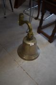 A large brass bell , with wall bracket