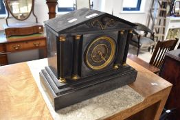 A Victorian black slate mantel clock, of architectural form with cast metal frieze and columns