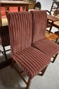A pair of modern dining chairs in red stripe upholstery