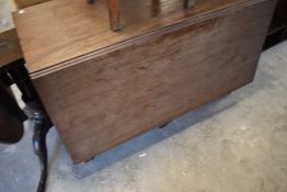 An 19th century mahogany drop-leaf dining table (no D-ends) gated or hinged supports to the plain
