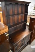 An early-mid 20th 20th century oak dresser and rack, of traditional design with geometric moulded