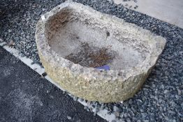 A large half moon trough , possibly limestone