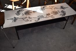 A vintage formica topped kitchen table having metal frame and printed leaf design, approx. 115 x