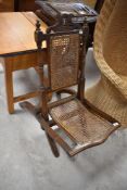 A 19th Century campaign style folding chair having bergere seat and back panel