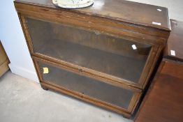 A vintage oak two tier stacking Globe Wernicke bookcase