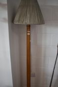 A vintage stained frame standard lamp having circular base and fluted column