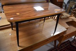 A vintage coffee table having inlay leaf style decoration to top on tapered legs, approx. 80 x 42cm