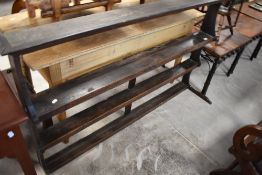 A 19th century oak plate or Delft rack, having a moulded cornice above three open shelves and